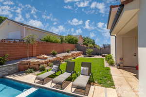 View of swimming pool with a fenced backyard, a lawn, a patio area, and a fenced in pool