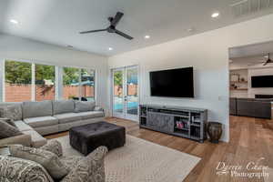 Living room with visible vents, wood finished floors, ceiling fan, and recessed lighting