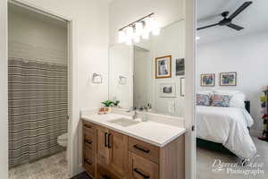Full bathroom with a ceiling fan, vanity, toilet, and ensuite bathroom
