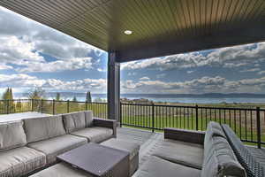View of patio featuring outdoor lounge area and a water view
