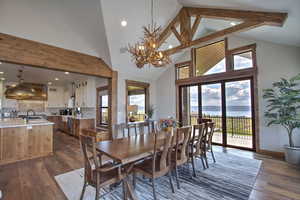Dining space with a healthy amount of sunlight, a chandelier, and beam ceiling