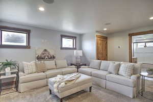Carpeted living area featuring recessed lighting