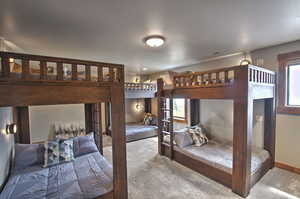 Bedroom with baseboards, visible vents, and carpet flooring