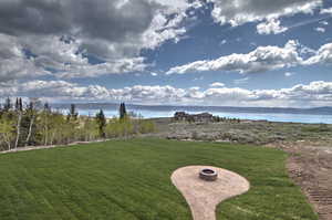 View of yard featuring a water view and a fire pit