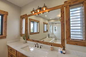 Bathroom featuring vanity, a freestanding tub, recessed lighting, and a shower stall