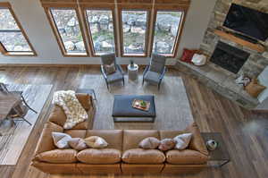 Living area with baseboards, a fireplace, and wood finished floors