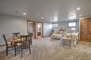 Carpeted dining space featuring baseboards and recessed lighting