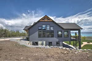 Rear view of house with a water view and roof with shingles