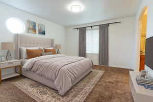 Primary Room. Carpeted bedroom featuring baseboards and arched walkways