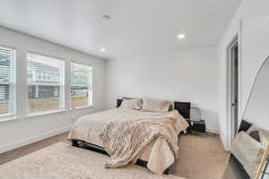 Primary Bedroom featuring baseboards, carpet floors, and recessed lighting