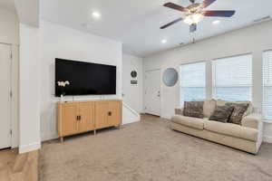 Living area featuring baseboards, visible vents, ceiling fan, and recessed lighting