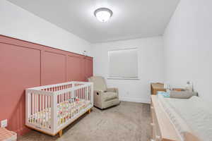 Carpeted bedroom featuring baseboards