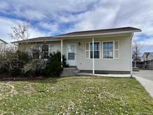 Bungalow-style house with a front yard and fence