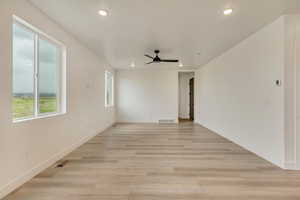 Unfurnished room with ceiling fan, visible vents, light wood-type flooring, and recessed lighting
