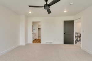 Unfurnished bedroom featuring light carpet, baseboards, visible vents, and recessed lighting