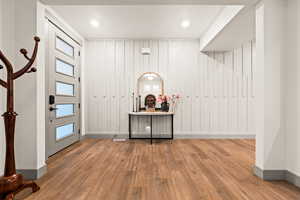 Foyer featuring baseboards and wood finished floors
