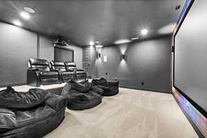 Carpeted home theater room featuring baseboards and recessed lighting