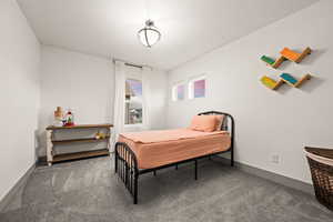 Bedroom with carpet flooring and baseboards