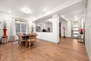 Dining room with baseboards, light wood-style flooring, and recessed lighting