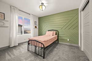 Carpeted bedroom featuring baseboards