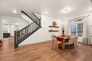 Dining area with baseboards, stairway, recessed lighting, and hardwood / wood-style floors