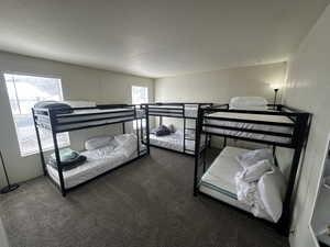 Bedroom with carpet floors and a textured ceiling