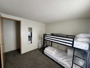 Bedroom featuring carpet flooring and a textured ceiling