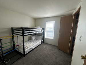 Carpeted bedroom featuring a textured ceiling