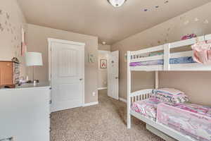 Bedroom with baseboards and light carpet