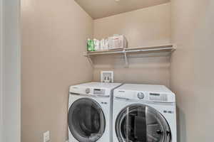 Laundry area featuring washer and clothes dryer and laundry area