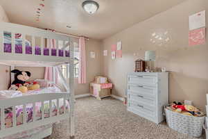 Bedroom with baseboards, visible vents, and carpet flooring