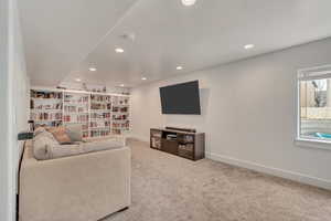 Carpeted living room featuring baseboards and recessed lighting