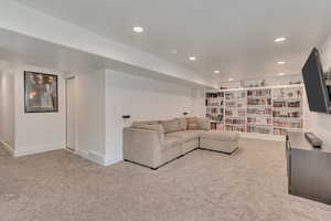 Unfurnished living room with baseboards, carpet floors, and recessed lighting