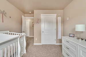 Bedroom with light carpet and baseboards