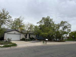 View of front of house featuring an attached garage and driveway