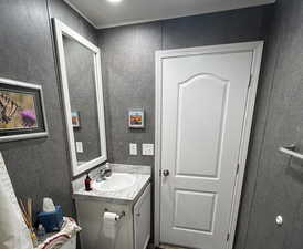 Guest bath with accent wall and laminate backsplash