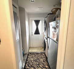 Laundry room with back door and room for storage