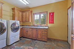 Laundry room with cabinets at garage entry
