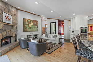 Living area featuring alder floors, fireplace, built in cabinets