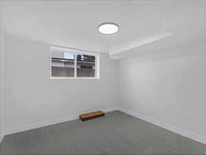 Spare room with baseboards and carpet floors