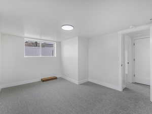 Spare room with baseboards and carpet flooring