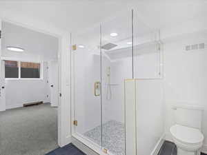 Full bath with a shower stall, baseboards, visible vents, and toilet