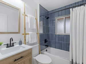 Full bath with  shower combination, toilet, and vanity