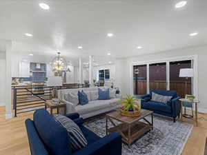 Living area with baseboards, light wood-type flooring, and recessed lighting