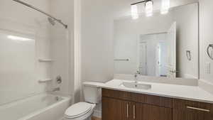 Full bath with toilet, vanity, and shower / tub combination