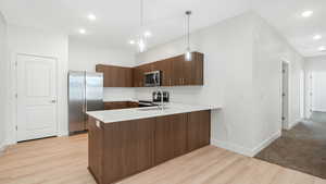 Kitchen featuring quartz countertops, tile backsplash, Stainless steel appliances, Fridge included!