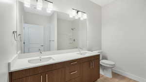 Primary bedroom en suite with walk in shower and double vanity.