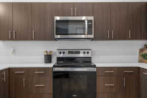 Kitchen featuring quartz countertops, tile backsplash, Stainless steel appliances