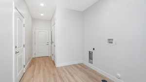 Laundry room with extra storage and access to the garage and common breezeway