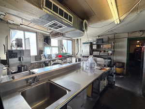 Kitchen featuring stainless steel countertops and a sink